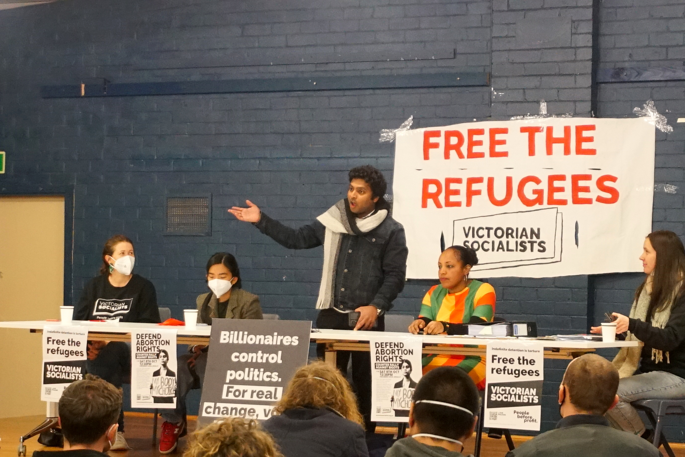 Anujan Tharumarasa, a Tamil refugee from Sri Lanka, speaks alongside Betelhem Tibebu Zeleke, a refugee from Ethiopia